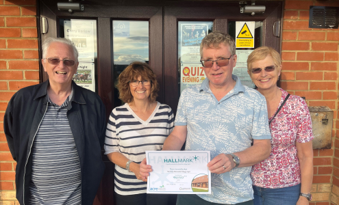 The trustees at Ramsey Mereside Village Hall being presented with their Hallmark certificate.