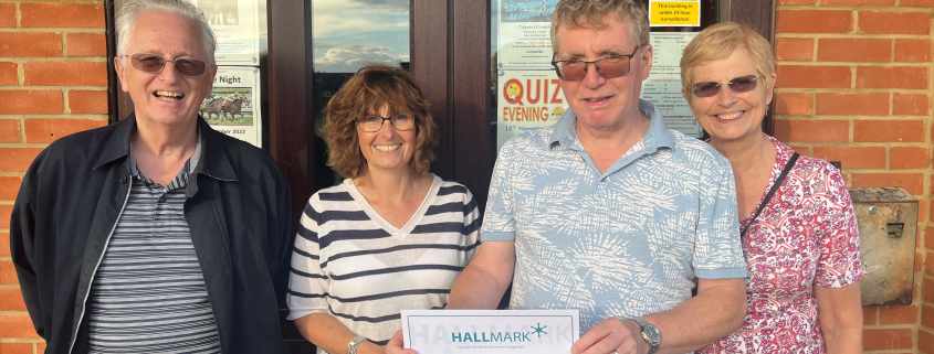 The trustees at Ramsey Mereside Village Hall being presented with their Hallmark certificate.