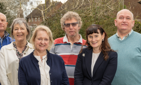 6 Trustees standing outside on a spring day